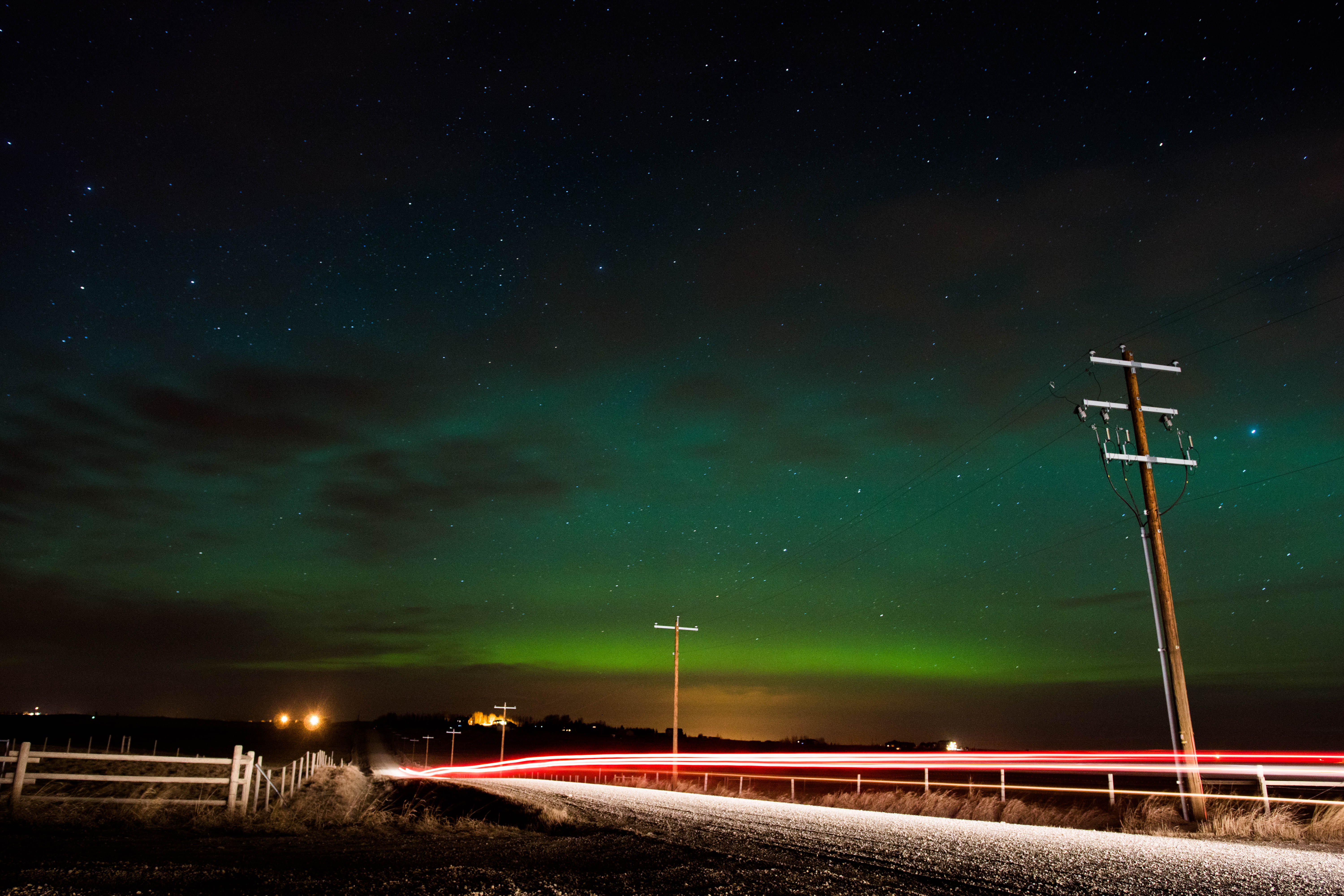 Aurora and car driving by
